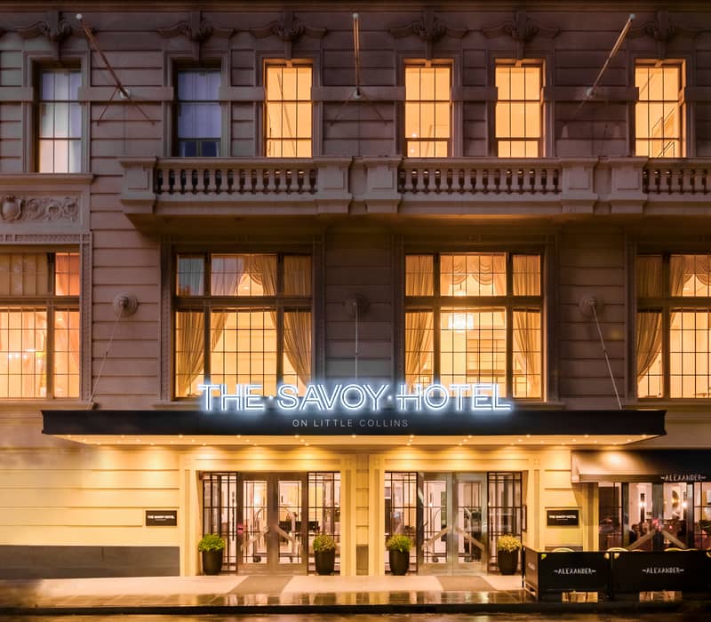 Luxury hotel bedroom with king bed and Art Deco ceiling details at The Savoy Hotel.